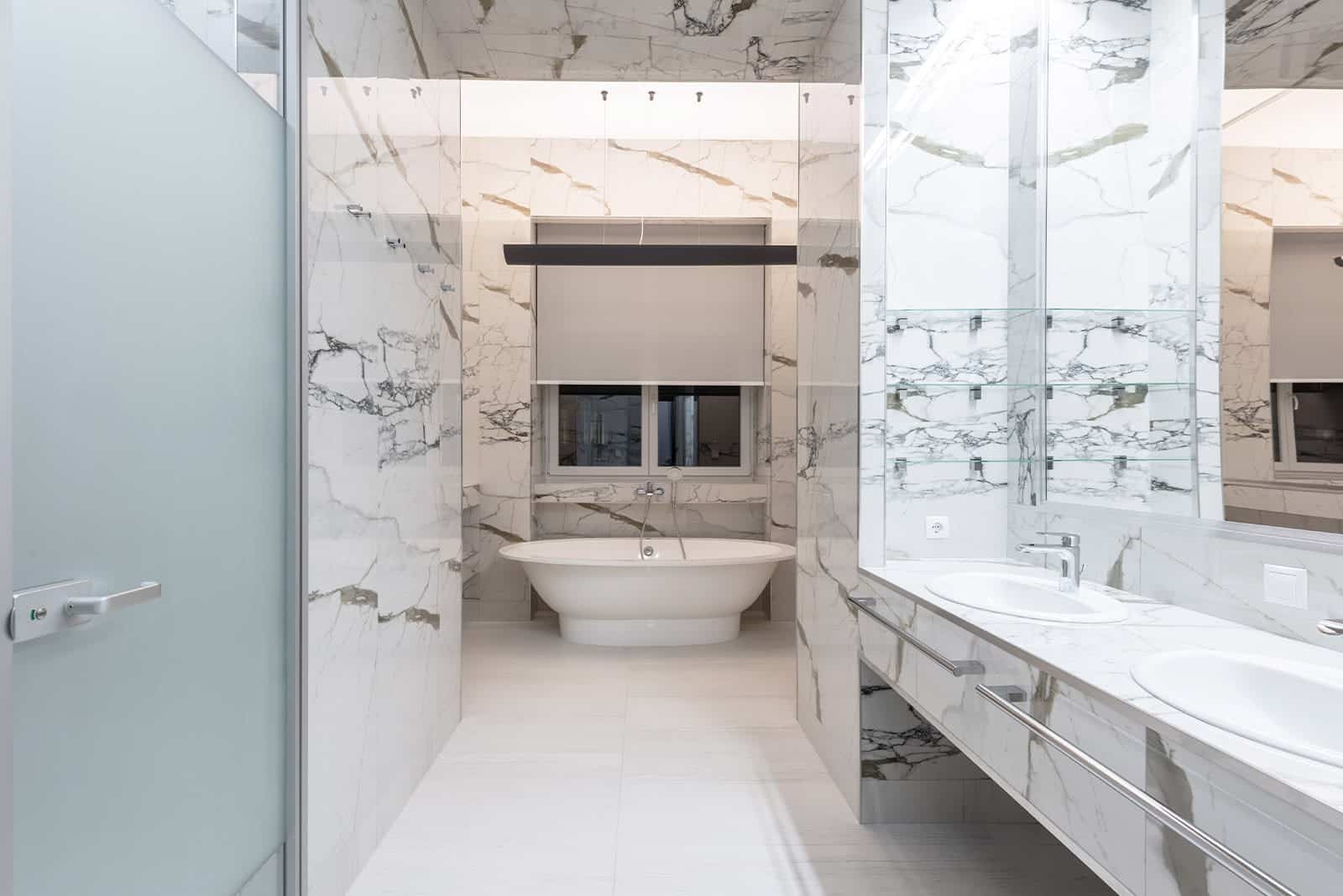 Modern bathroom renovation with glass shower, vanity and tile finishes